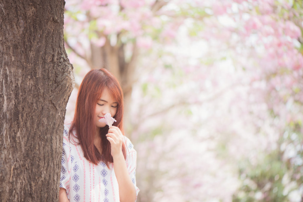 It's a girl smelling a flower and it represents part of the article Life Purpose: How to find Your Life Purpose